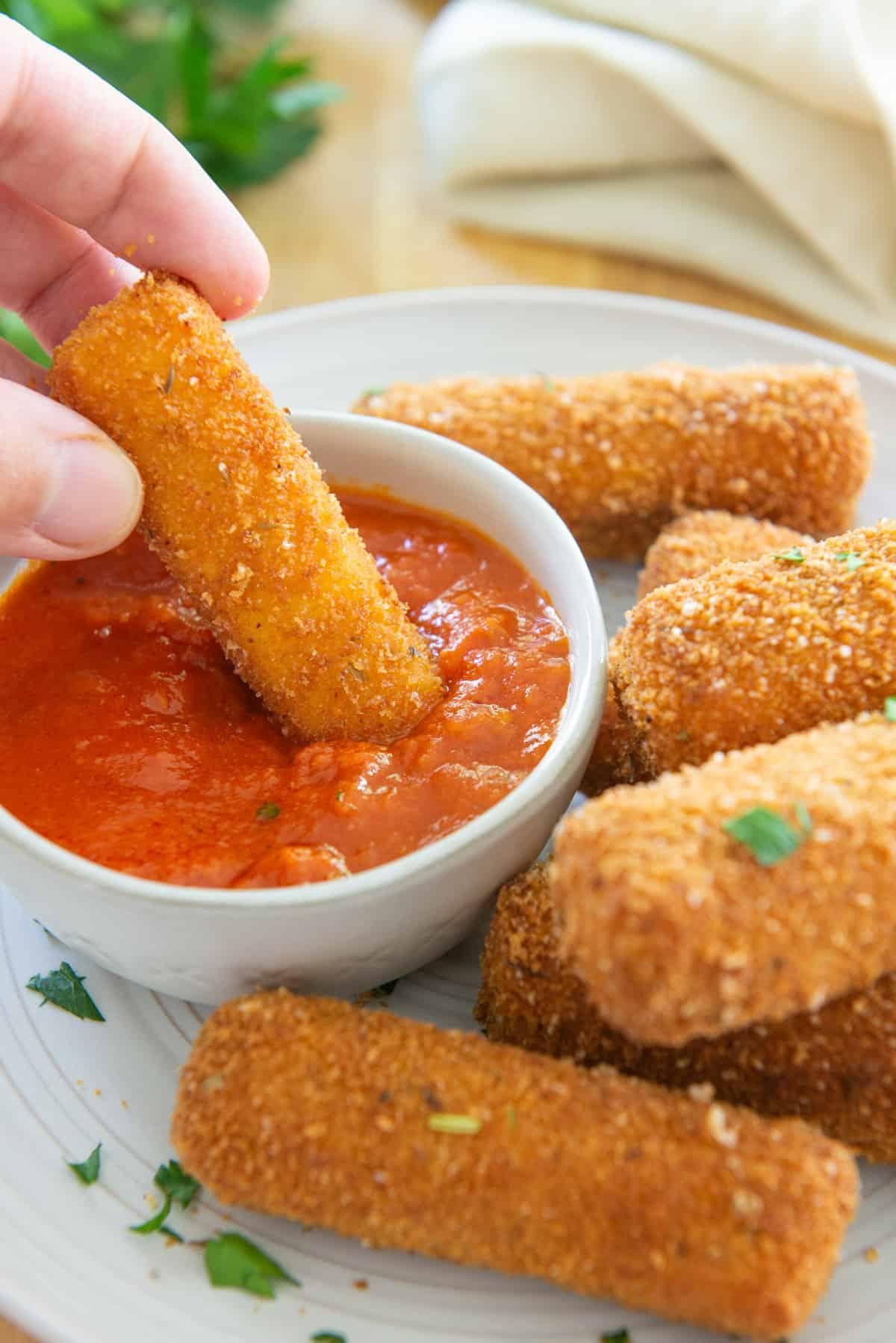 Dipping a Mozzarella Cheese Stick Into marinara Sauce